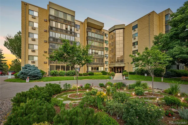 front view of a residential apartment building with a yard