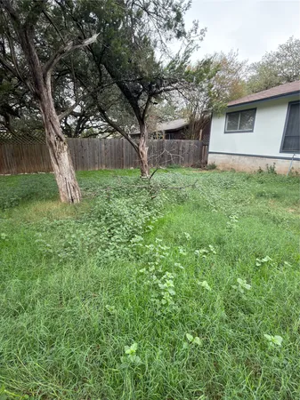 a view of a house with a backyard