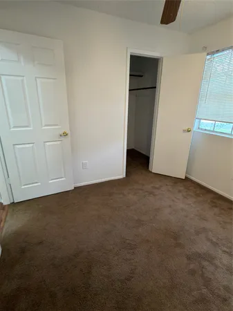 an empty room with closet area