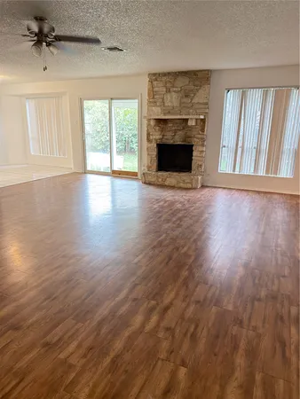 a view of a room with an empty space and wooden floor