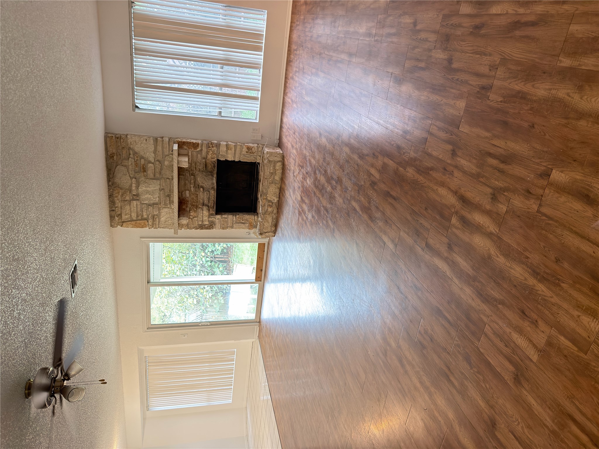 5601 Porsche Lane Austin, TX 78749 - Photo 36 of 38 an empty room with wooden floor fireplace and windows