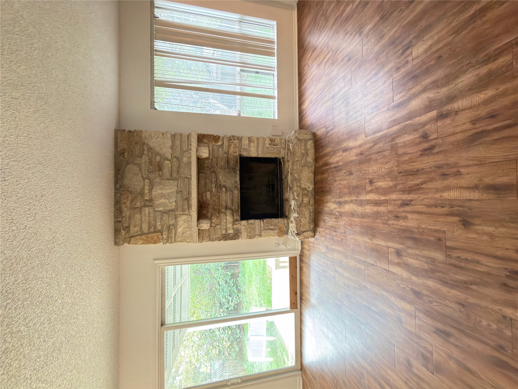 5601 Porsche Lane Austin, TX 78749 - Photo 7 of 38 an empty room with wooden floor fireplace and windows