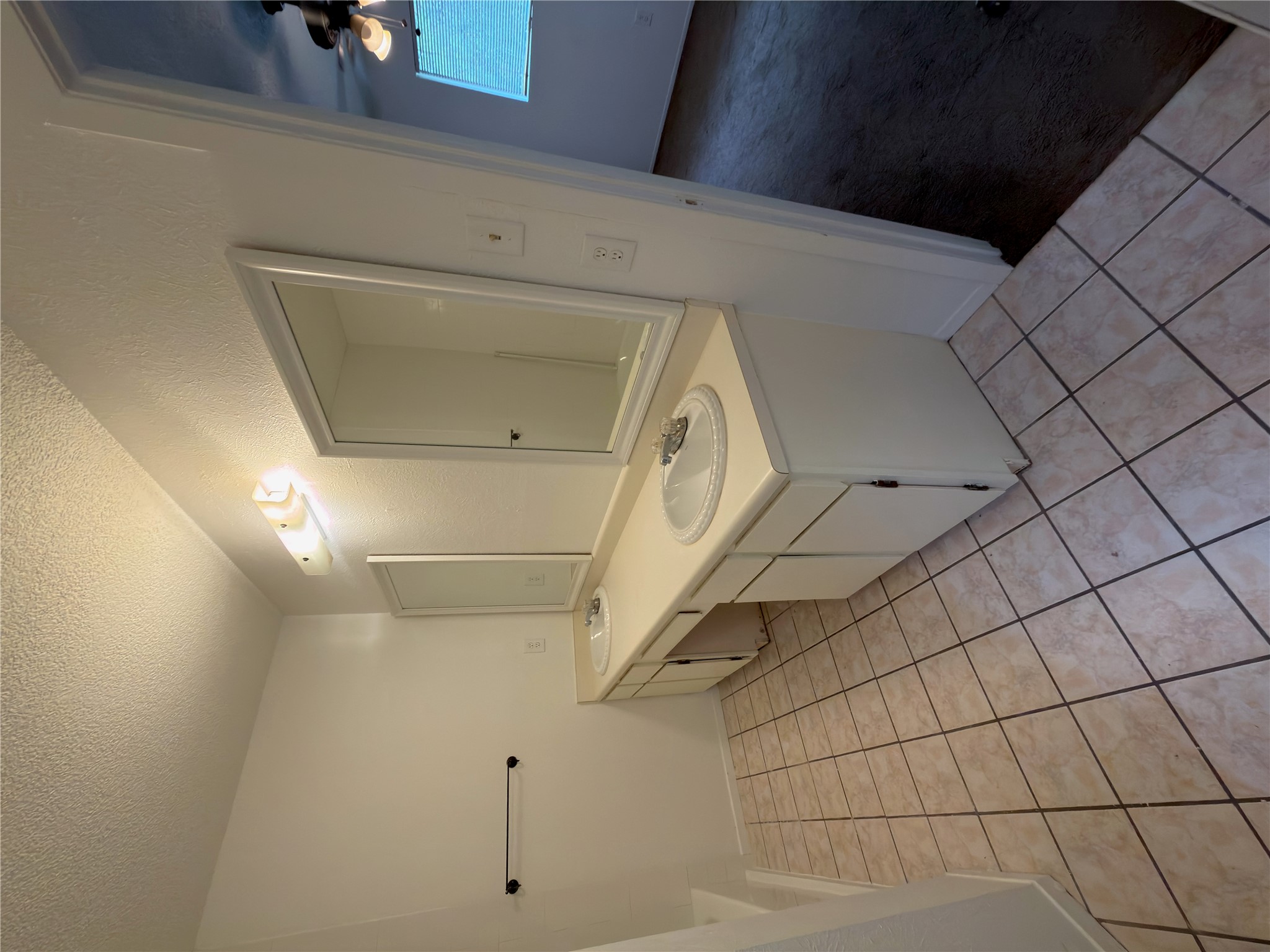 5601 Porsche Lane Austin, TX 78749 - Photo 10 of 38 a bathroom with a sink a toilet and a mirror
