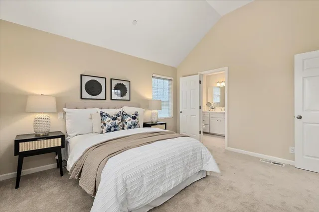 a bedroom with a bed and a lamp