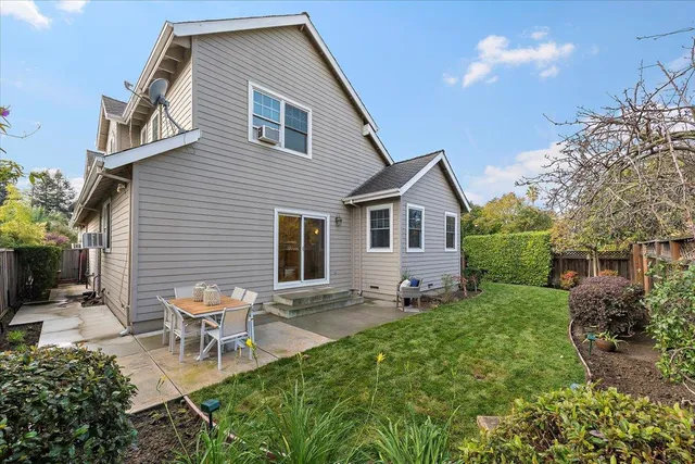 a backyard of a house with outdoor seating