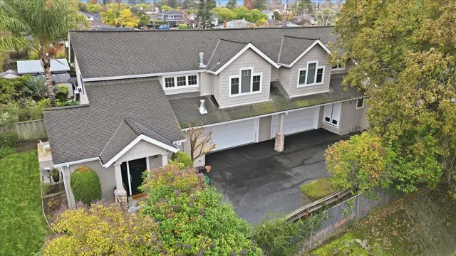 an aerial view of a house with a yard