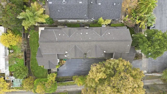 an aerial view of a house with a yard