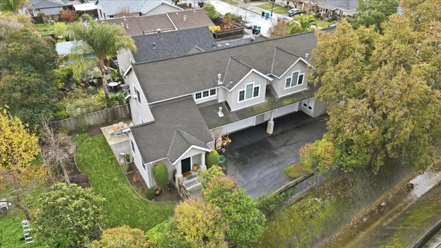 an aerial view of a house with a yard