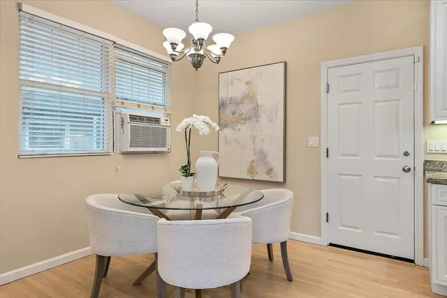 a view of a dining room with furniture wooden floor and chandelier