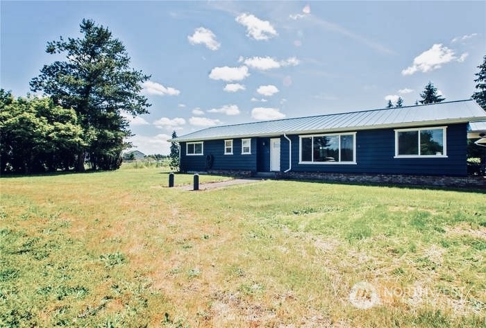 a view of house with yard