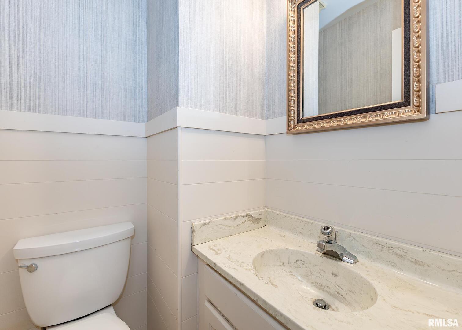 3407 41st Street Moline, IL 61265 - Photo 13 of 25 a bathroom with a sink toilet and mirror