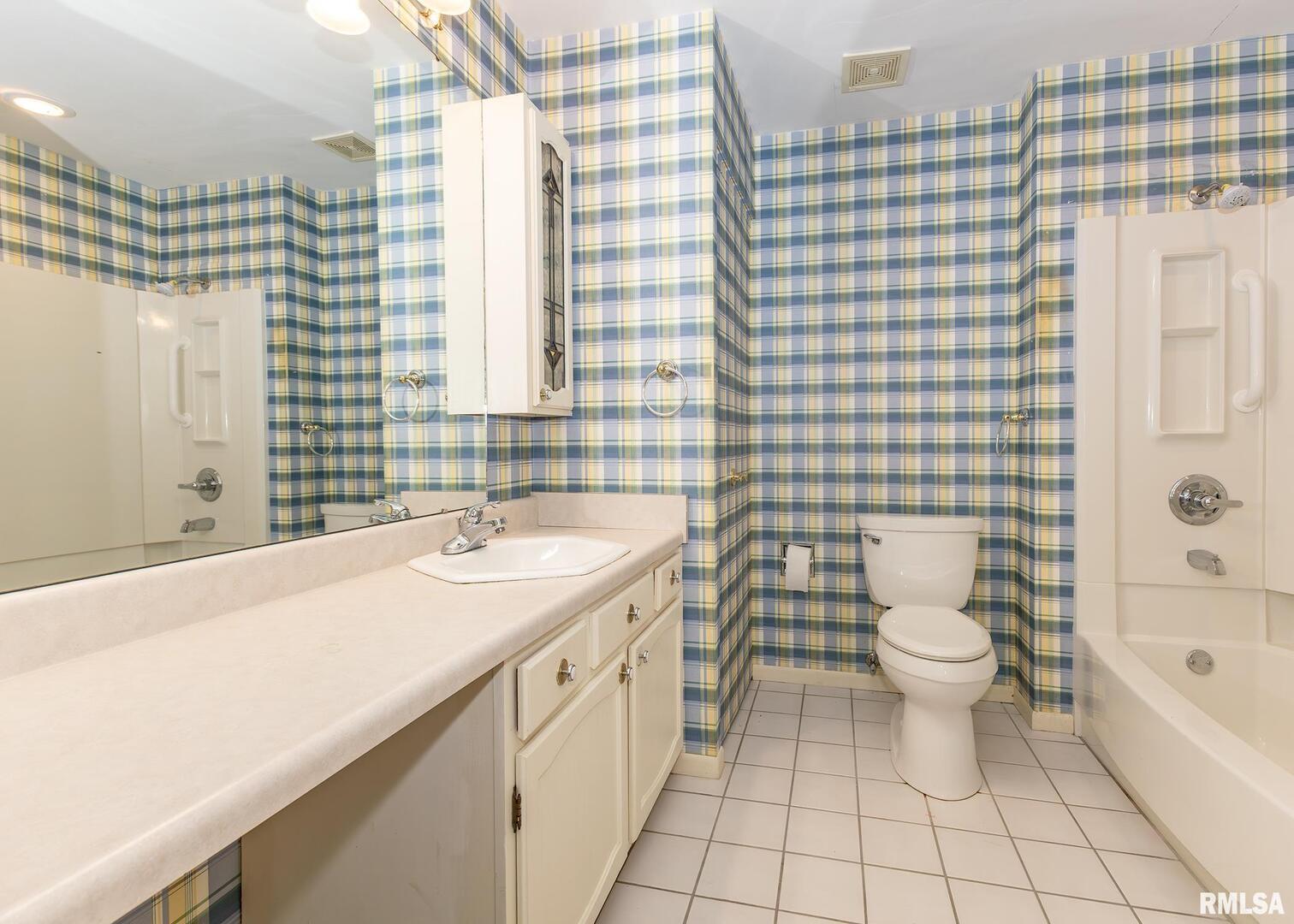 3407 41st Street Moline, IL 61265 - Photo 15 of 25 a bathroom with a sink a toilet and shower