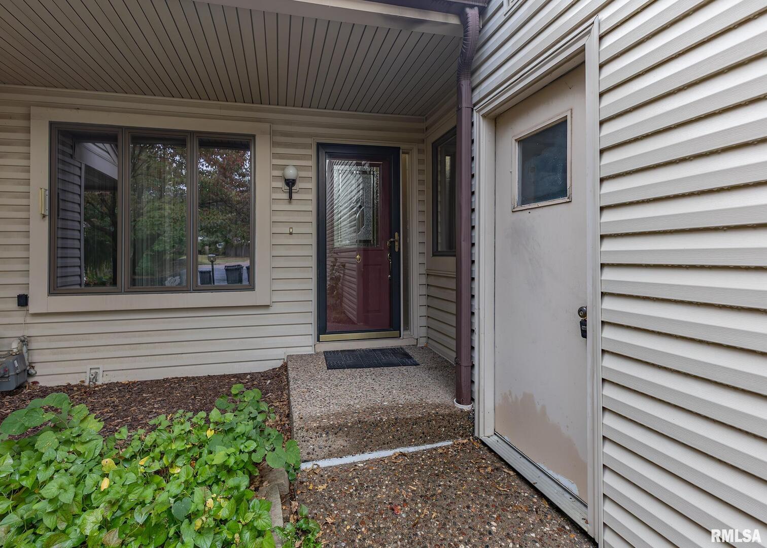 3407 41st Street Moline, IL 61265 - Photo 2 of 25 a view of front door and porch with seating space