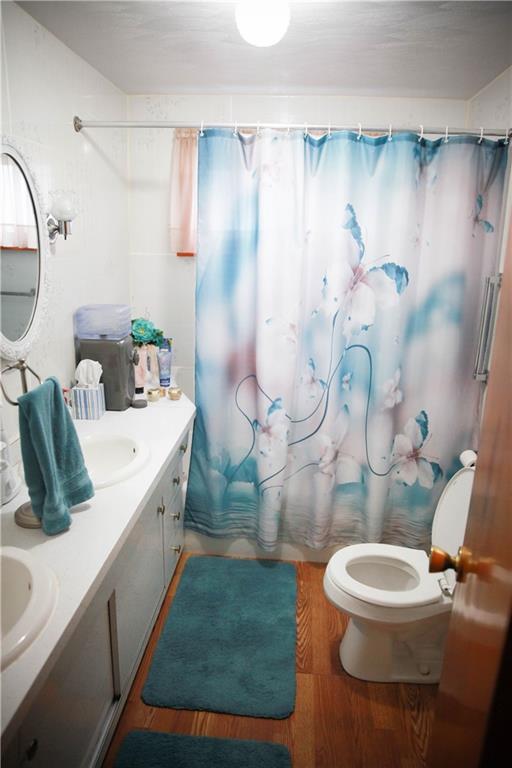 411 Reservoir Road Dunbar, PA 15431 - Photo 12 of 18 a bathroom with a sink a toilet and a mirror