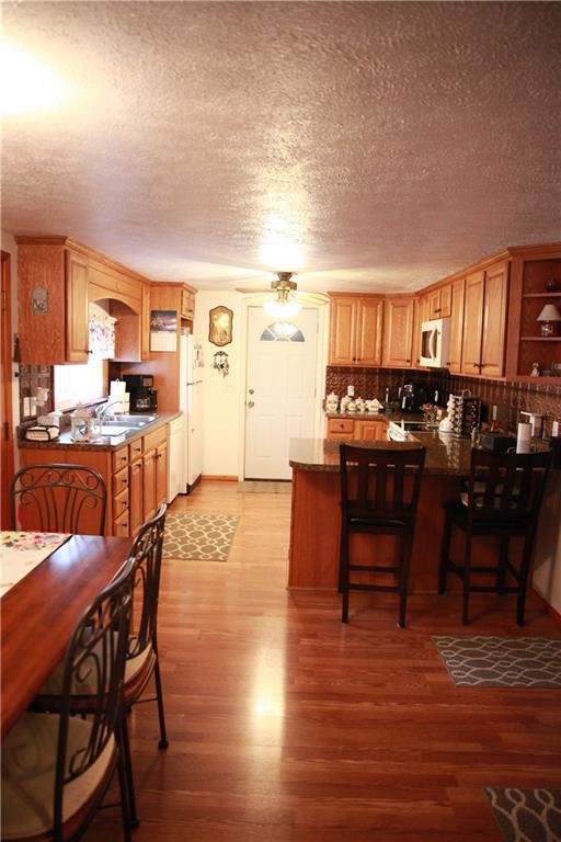 411 Reservoir Road Dunbar, PA 15431 - Photo 8 of 18 a view of a dining room with furniture and wooden floor