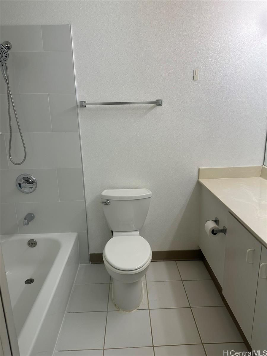 94-209 Lumiaina Place, Unit J203 Waipahu, HI 96797 - Photo 14 of 19 a bathroom with a sink a toilet and a bathtub