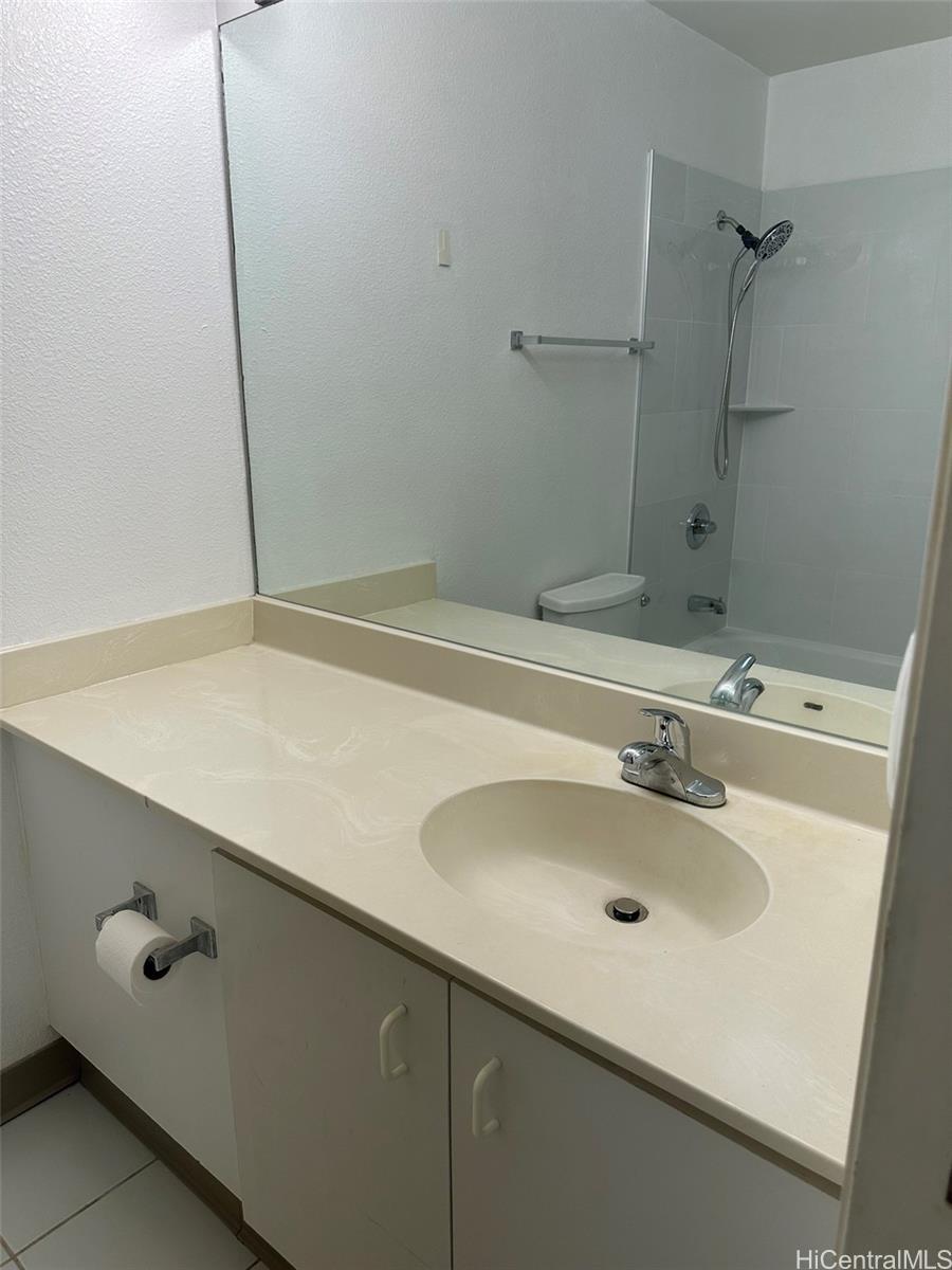 94-209 Lumiaina Place, Unit J203 Waipahu, HI 96797 - Photo 15 of 19 a bathroom with a sink and a mirror