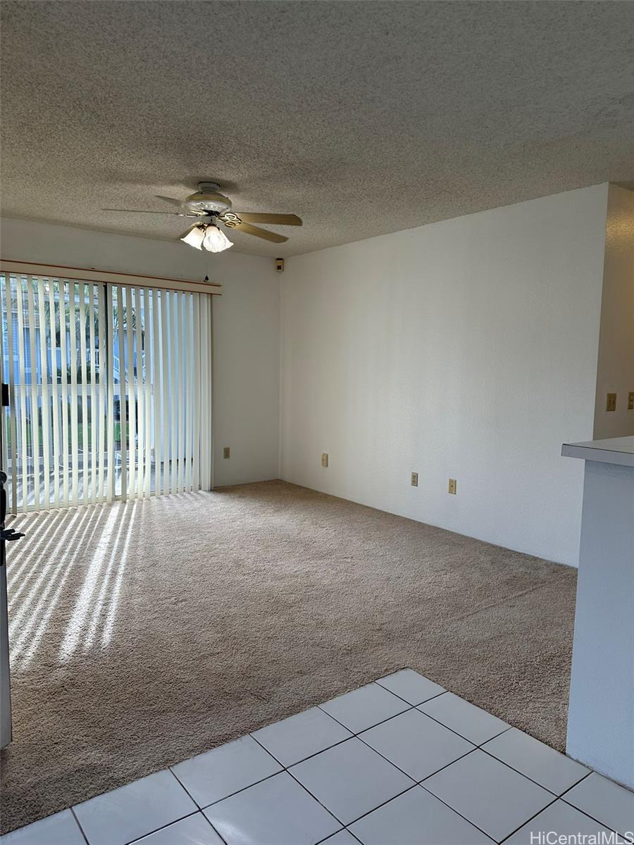 94-209 Lumiaina Place, Unit J203 Waipahu, HI 96797 - Photo 2 of 19 a view of a livingroom with a ceiling fan and window