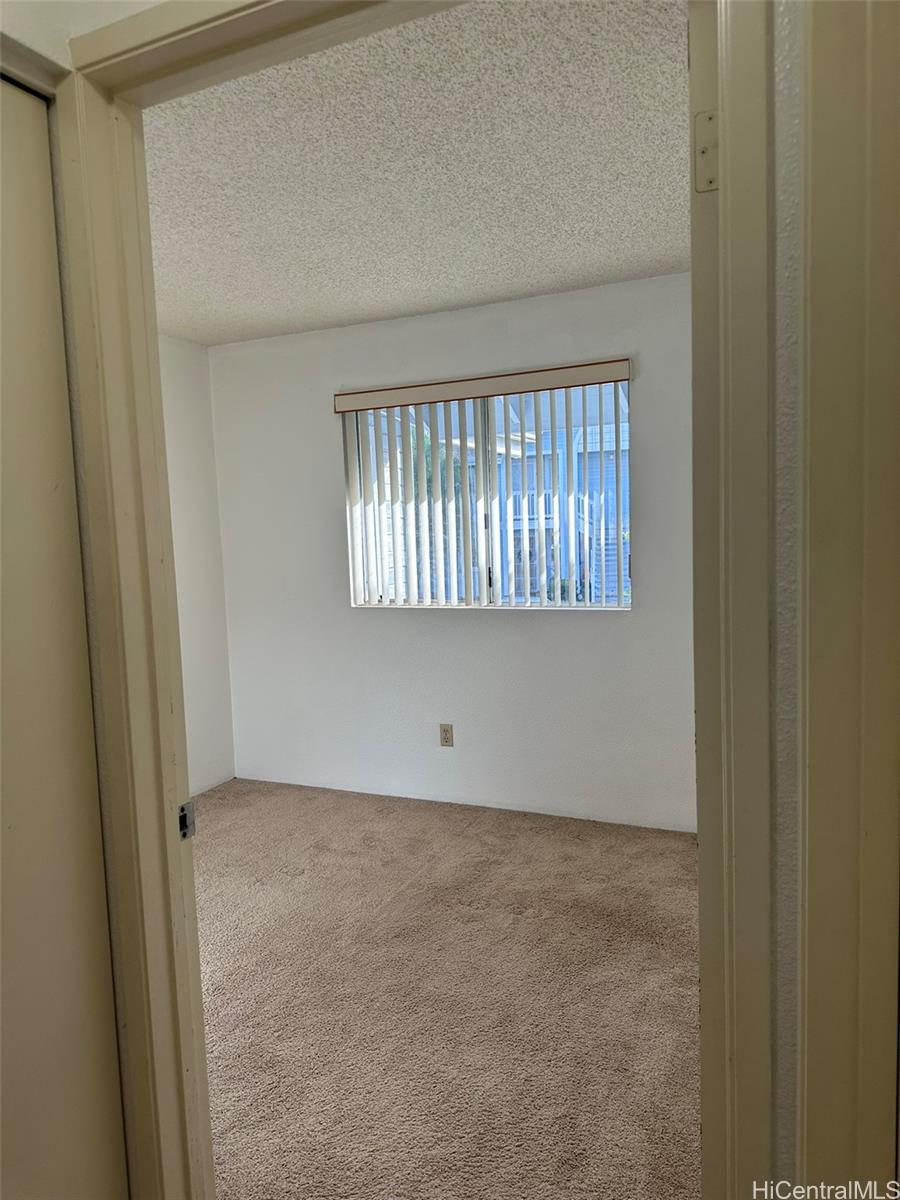 94-209 Lumiaina Place, Unit J203 Waipahu, HI 96797 - Photo 8 of 19 an empty room with windows