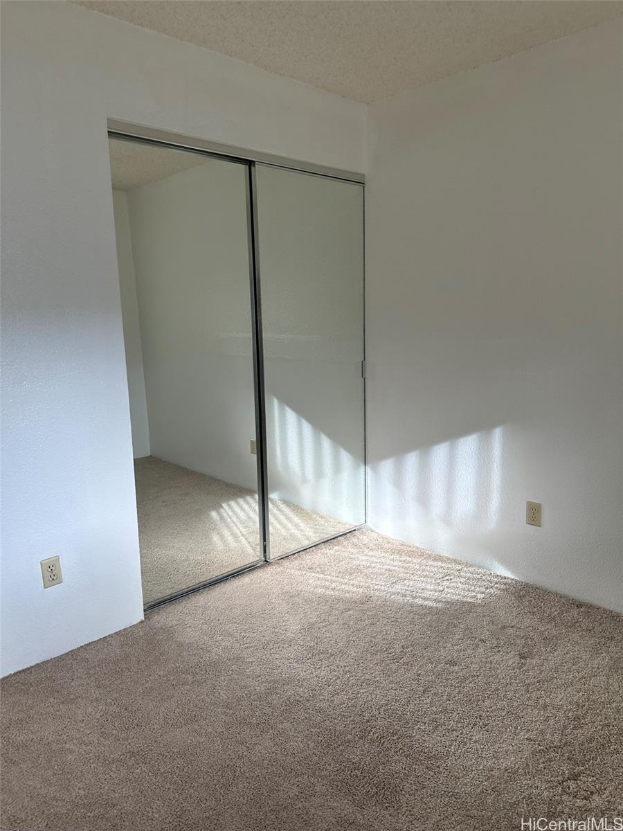 94-209 Lumiaina Place, Unit J203 Waipahu, HI 96797 - Photo 10 of 19 a view of an empty room with a window