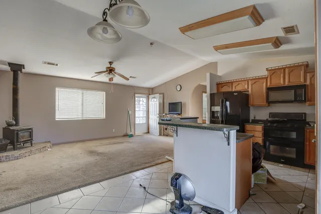 a view of a kitchen with appliances and furniture