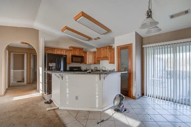 a kitchen with stainless steel appliances granite countertop a sink stove and cabinets