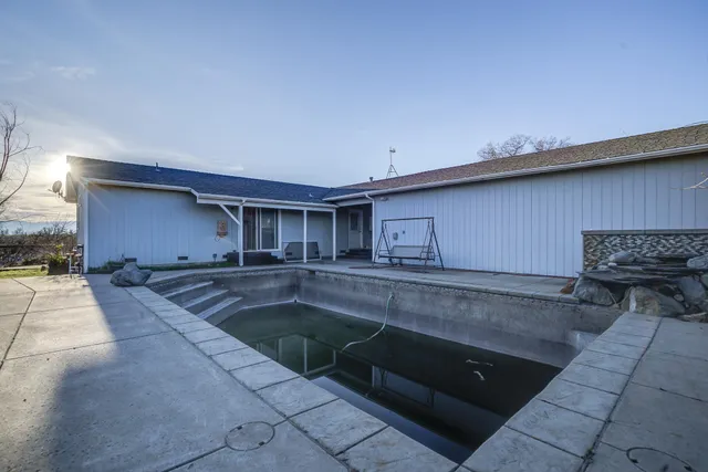 a view of a kitchen with a sink and dishwasher with wooden floor