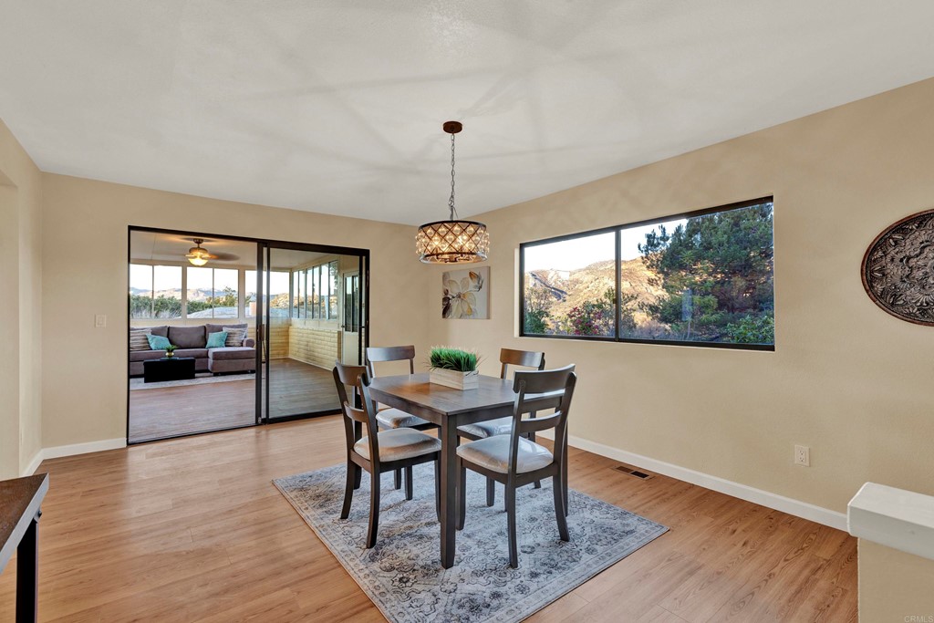 12032 Serena Road Lakeside, CA 92040 - Photo 19 of 55 a view of a dining room with furniture window and wooden floor
