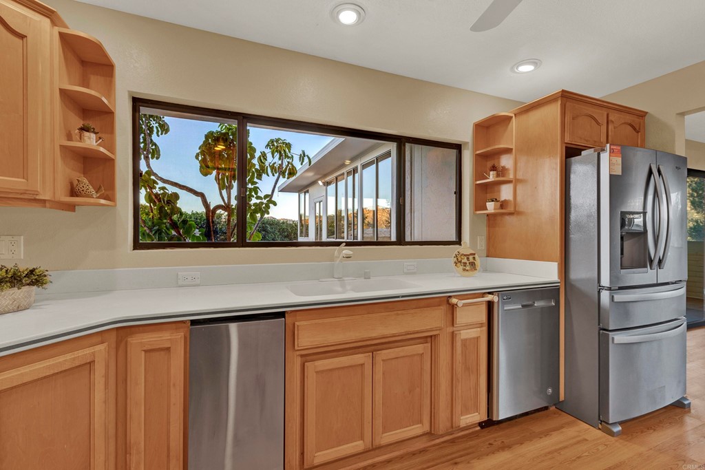 12032 Serena Road Lakeside, CA 92040 - Photo 22 of 55 a kitchen with stainless steel appliances granite countertop a refrigerator and a sink