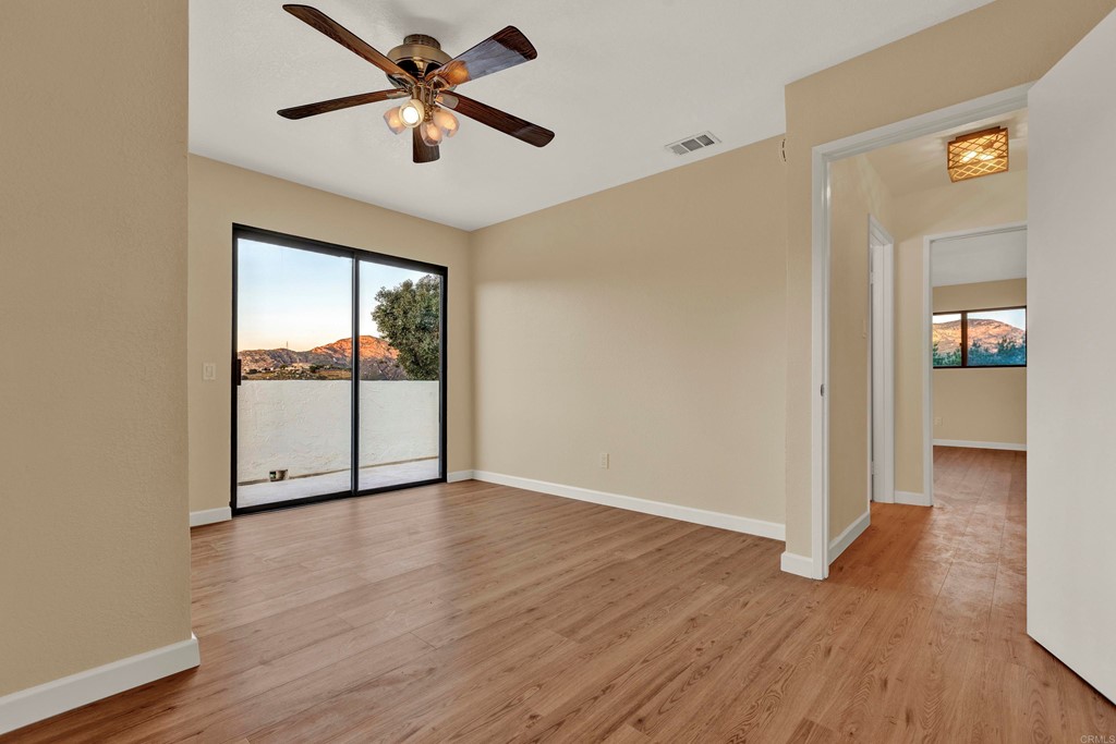 12032 Serena Road Lakeside, CA 92040 - Photo 35 of 55 a view of a livingroom with wooden floor and a ceiling fan