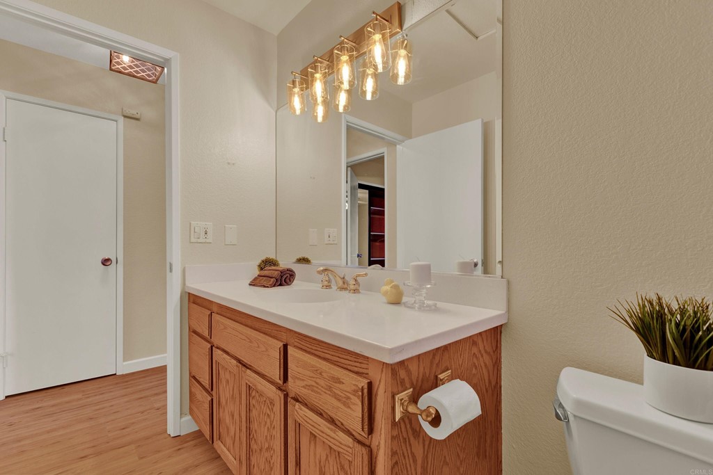 12032 Serena Road Lakeside, CA 92040 - Photo 40 of 55 a bathroom with a sink a toilet and a mirror