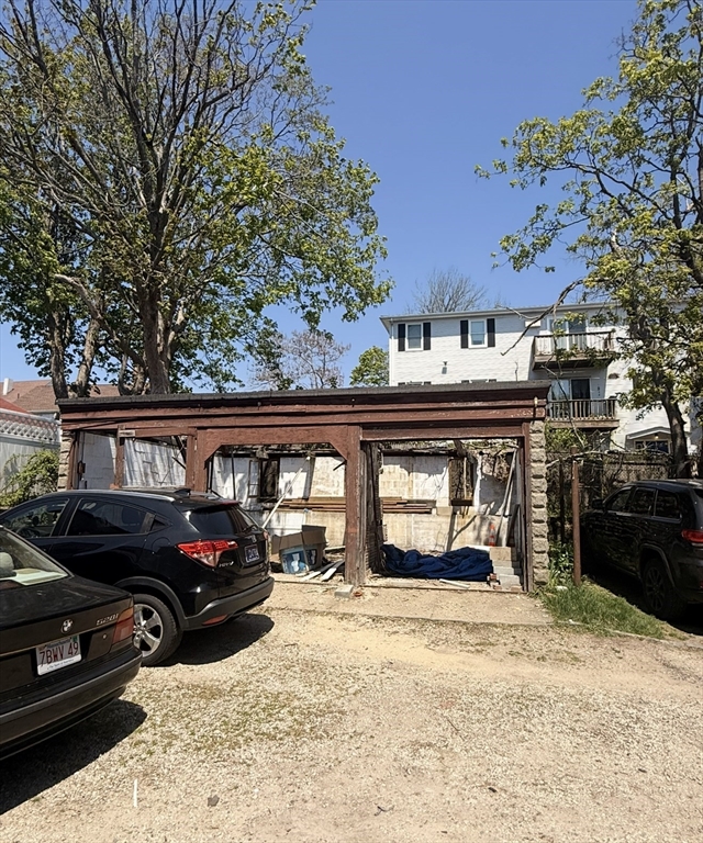 630 Maple Street Fall River, MA 02720 - Photo 4 of 4 a front view of a house with a yard and garage