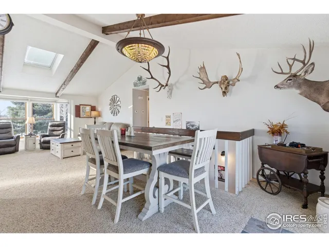 a dining room with a wooden table and chairs