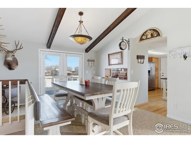 a view of a dining room with furniture and a chandelier