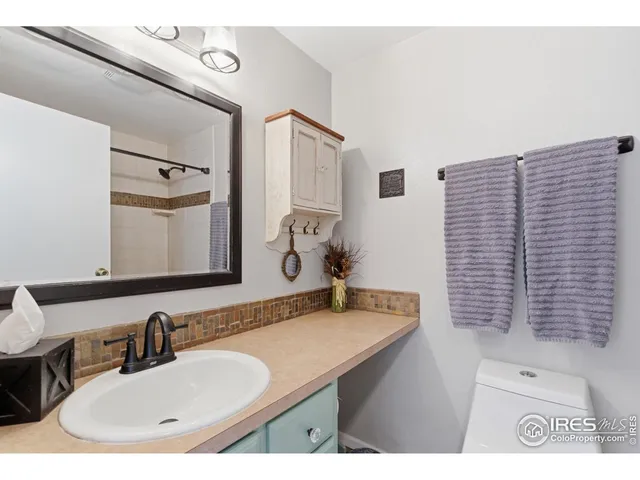 a bathroom with a sink vanity and a mirror