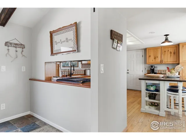 a living room with furniture and painting on the wall