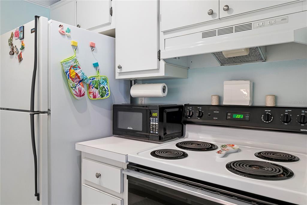 3273 South Beneva Road, Unit 203 Sarasota, FL 34232 - Photo 12 of 36 a kitchen with a refrigerator and a stove