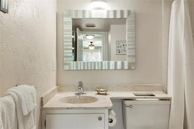 a bathroom with a sink a toilet and bathtub