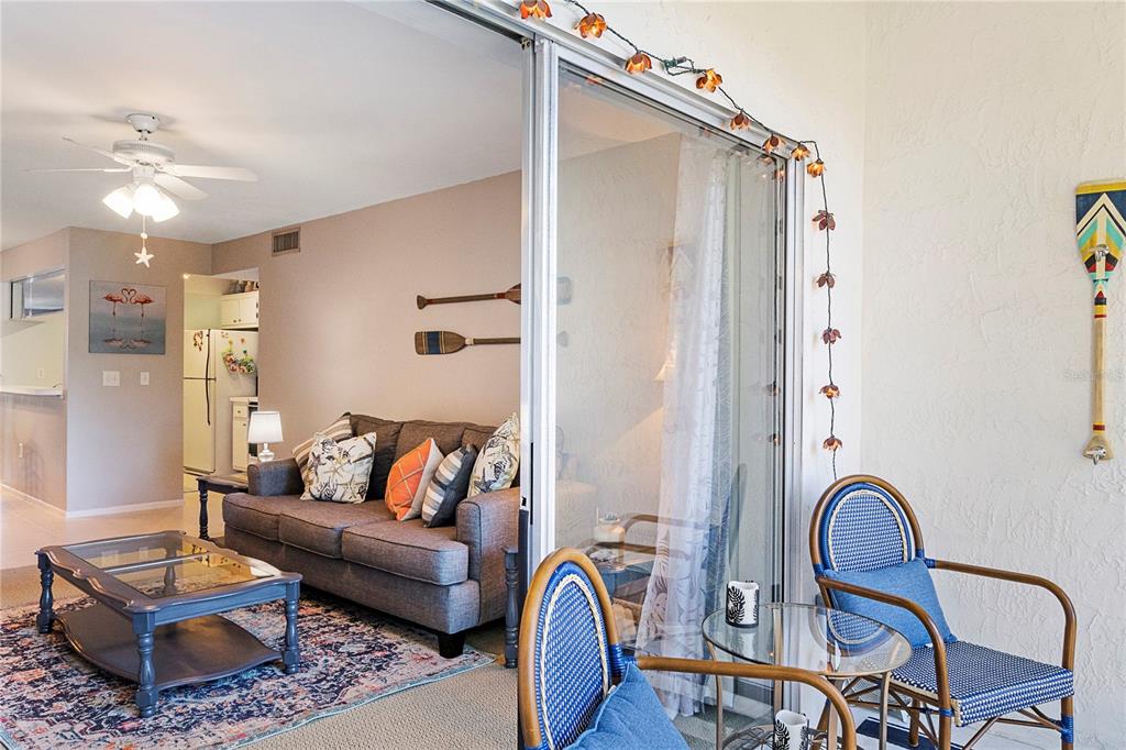 3273 South Beneva Road, Unit 203 Sarasota, FL 34232 - Photo 18 of 36 a living room with furniture and a chandelier