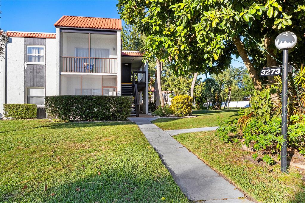 3273 South Beneva Road, Unit 203 Sarasota, FL 34232 - Photo 2 of 36 a front view of a house with a yard