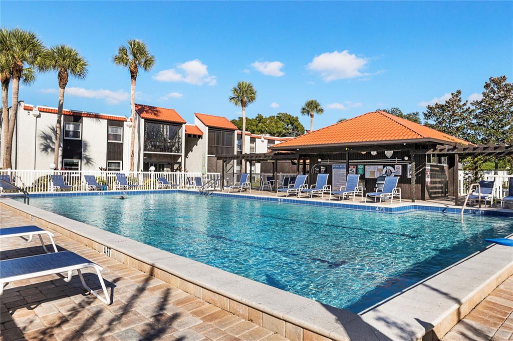 3273 South Beneva Road, Unit 203 Sarasota, FL 34232 - Photo 23 of 36 a view of a patio with chairs and umbrellas on a deck
