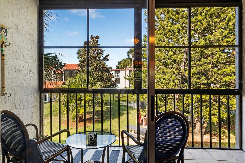 3273 South Beneva Road, Unit 203 Sarasota, FL 34232 - Photo 3 of 36 a view of a chairs and table in the balcony
