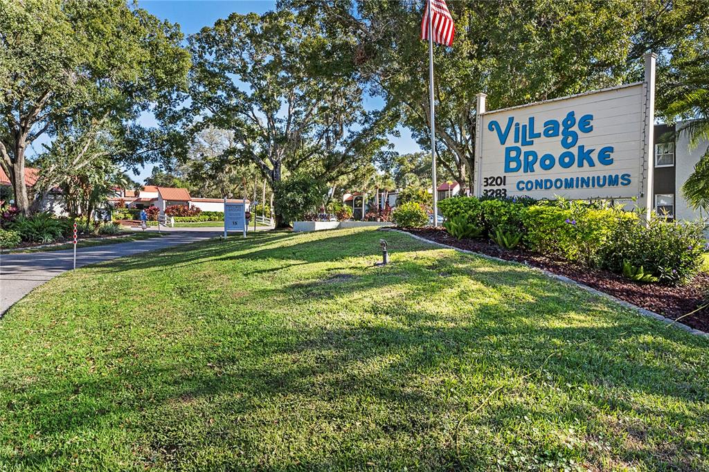 3273 South Beneva Road, Unit 203 Sarasota, FL 34232 - Photo 31 of 36 a sign that is sitting in front of a house with a tree