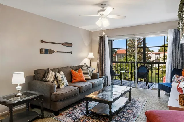 a living room with furniture and a floor to ceiling window