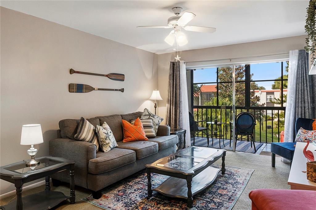 3273 South Beneva Road, Unit 203 Sarasota, FL 34232 - Photo 4 of 36 a living room with furniture and a floor to ceiling window