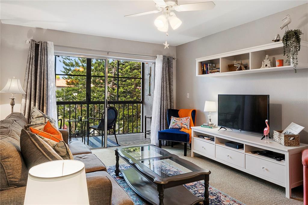 3273 South Beneva Road, Unit 203 Sarasota, FL 34232 - Photo 6 of 36 a living room with furniture and a flat screen tv