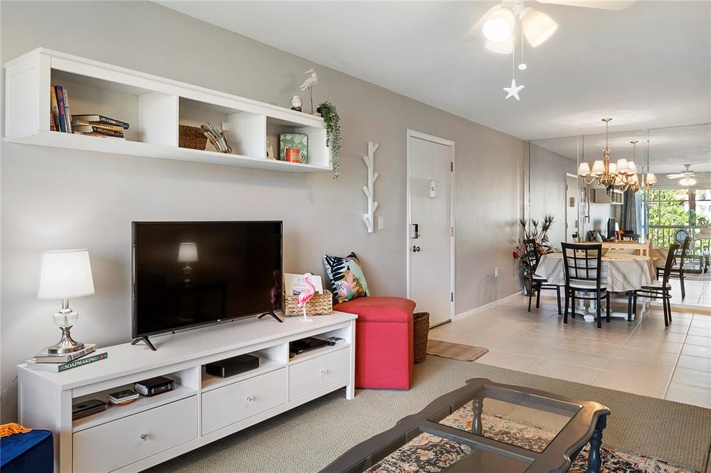 3273 South Beneva Road, Unit 203 Sarasota, FL 34232 - Photo 8 of 36 a living room with furniture and a flat screen tv