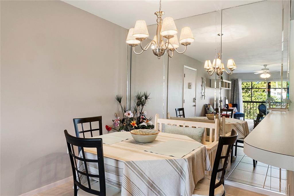 3273 South Beneva Road, Unit 203 Sarasota, FL 34232 - Photo 9 of 36 a view of a dining room with furniture and chandelier
