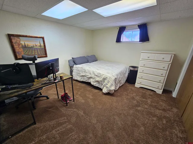 a white toilet sitting next to a small window
