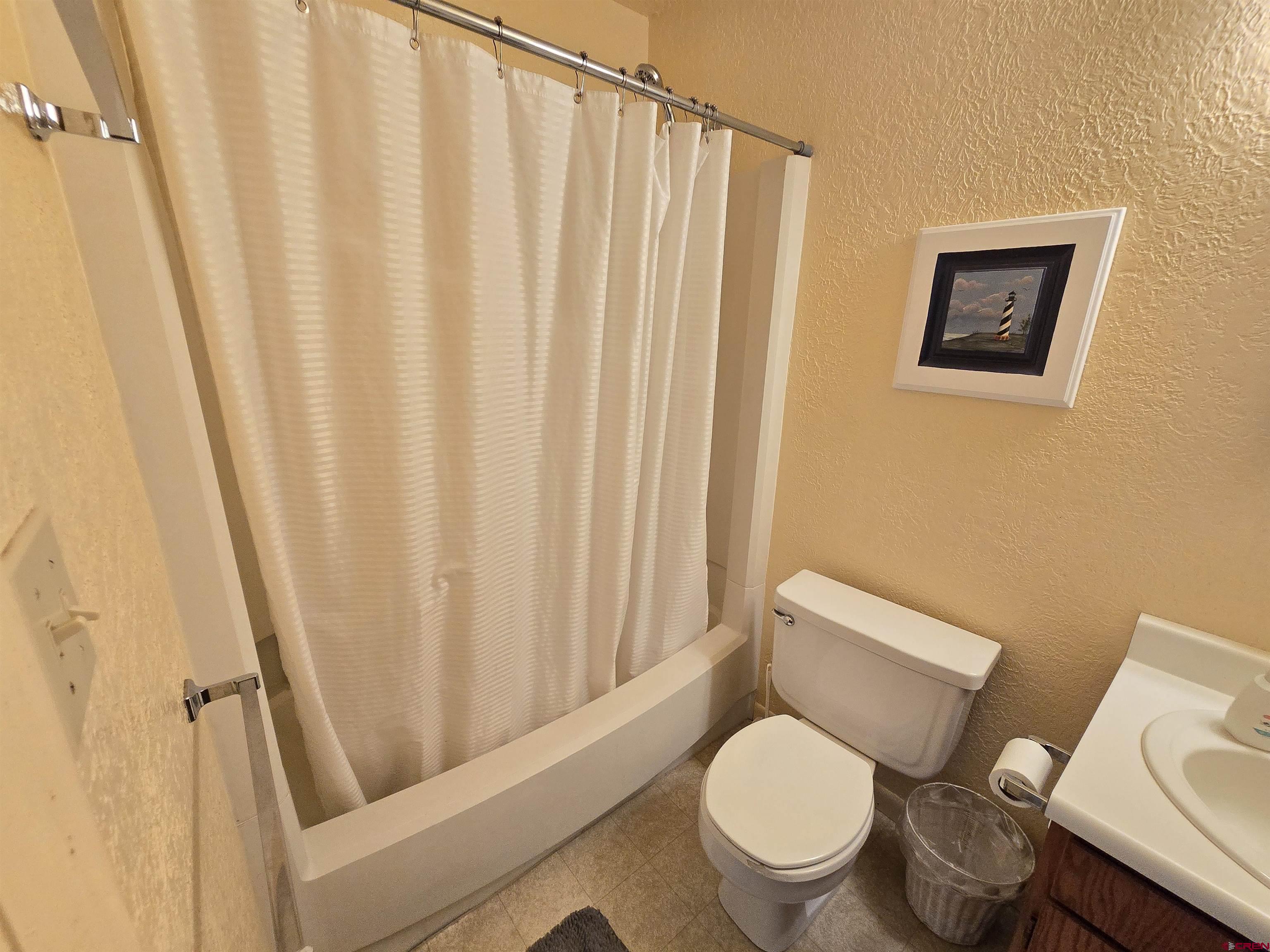 4590 Sierra Vista Road Alamosa, CO 81101 - Photo 14 of 31 a white toilet sitting next to a small window